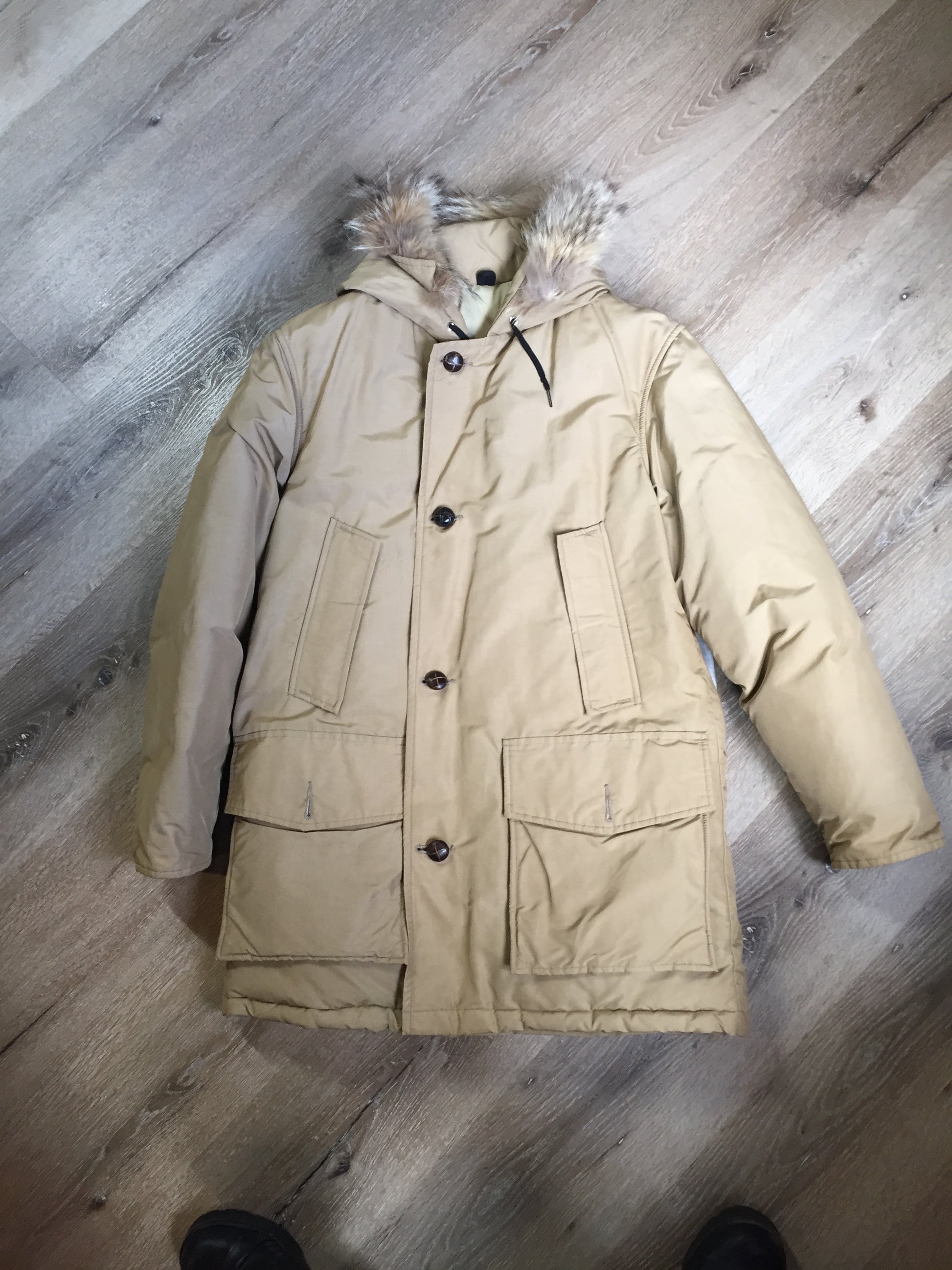 Kingspier Vintage - Woolrich goose down parka in beige with fur trimmed hood, slash pockets and flap pockets and inside pocket, zipper and button closures, Size small.