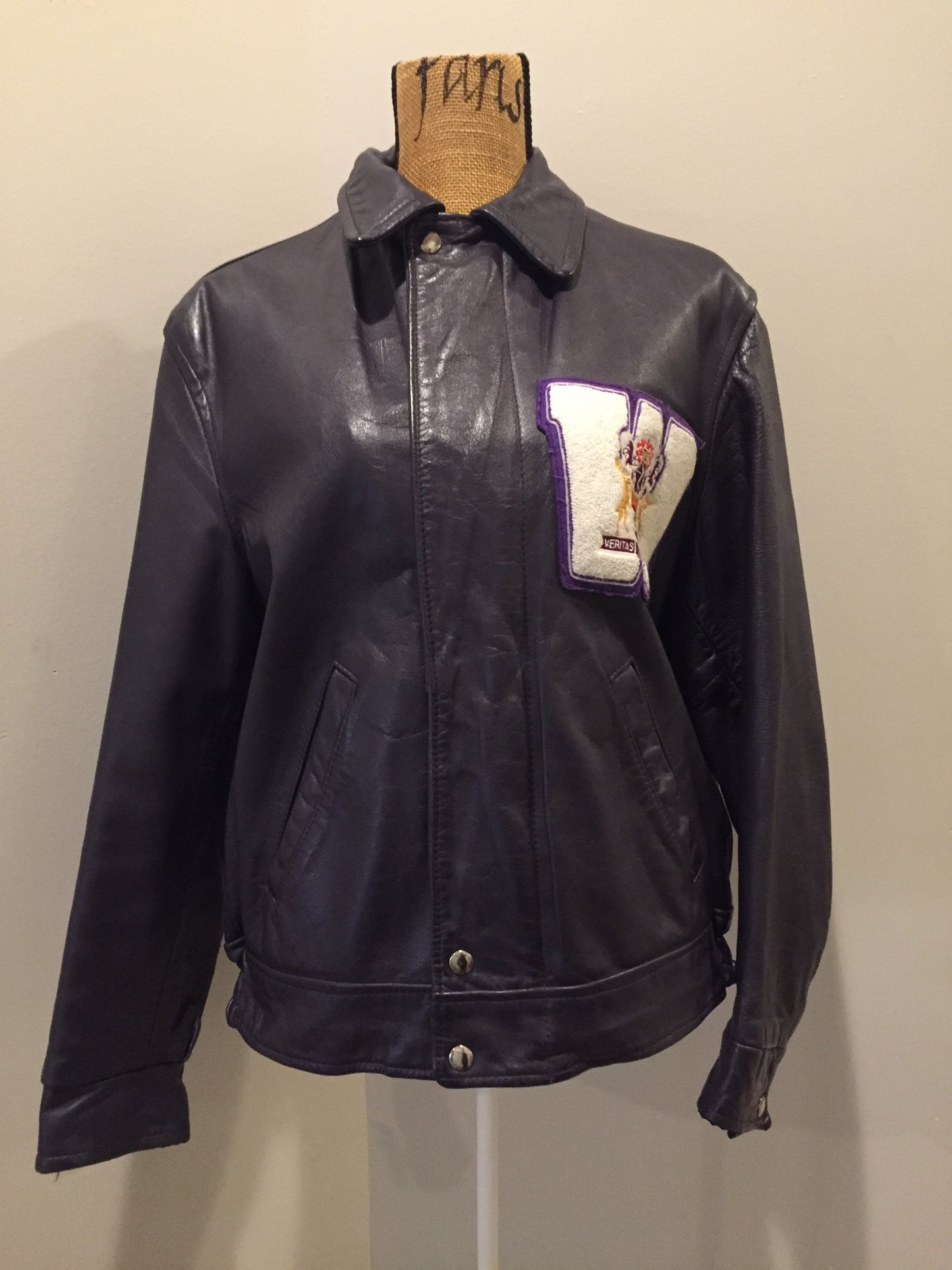 Kingspier Vintage - Western University leather varsity jacket in deep purple with slash pockets and snap closures, emblem embroidered on the chest and “Western” written across the back.