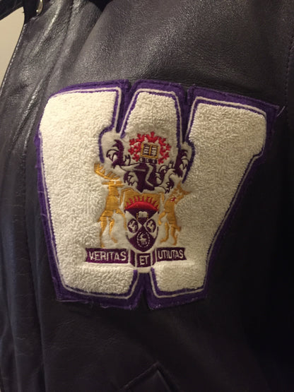 Kingspier Vintage - Western University leather varsity jacket in deep purple with slash pockets and snap closures, emblem embroidered on the chest and “Western” written across the back.