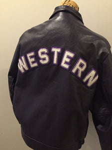 Kingspier Vintage - Western University leather varsity jacket in deep purple with slash pockets and snap closures, emblem embroidered on the chest and “Western” written across the back.