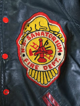 Load image into Gallery viewer, Kingspier Vintage - NS Sanitorium Fire Department green leather varsity jacket with red details, snap closures, slash pockets, embroidered emblem on the chest, embroidered monogram on the arm and shearling lining.
