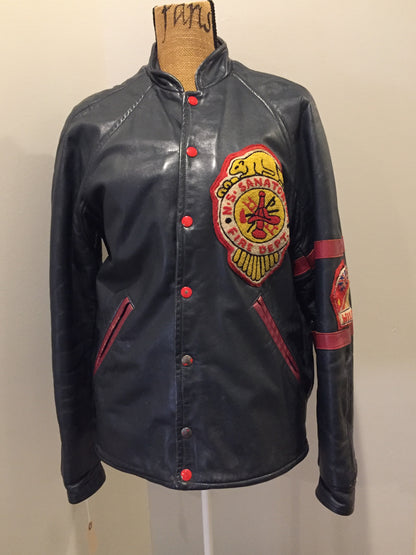 Kingspier Vintage - NS Sanitorium Fire Department green leather varsity jacket with red details, snap closures, slash pockets, embroidered emblem on the chest, embroidered monogram on the arm and shearling lining.