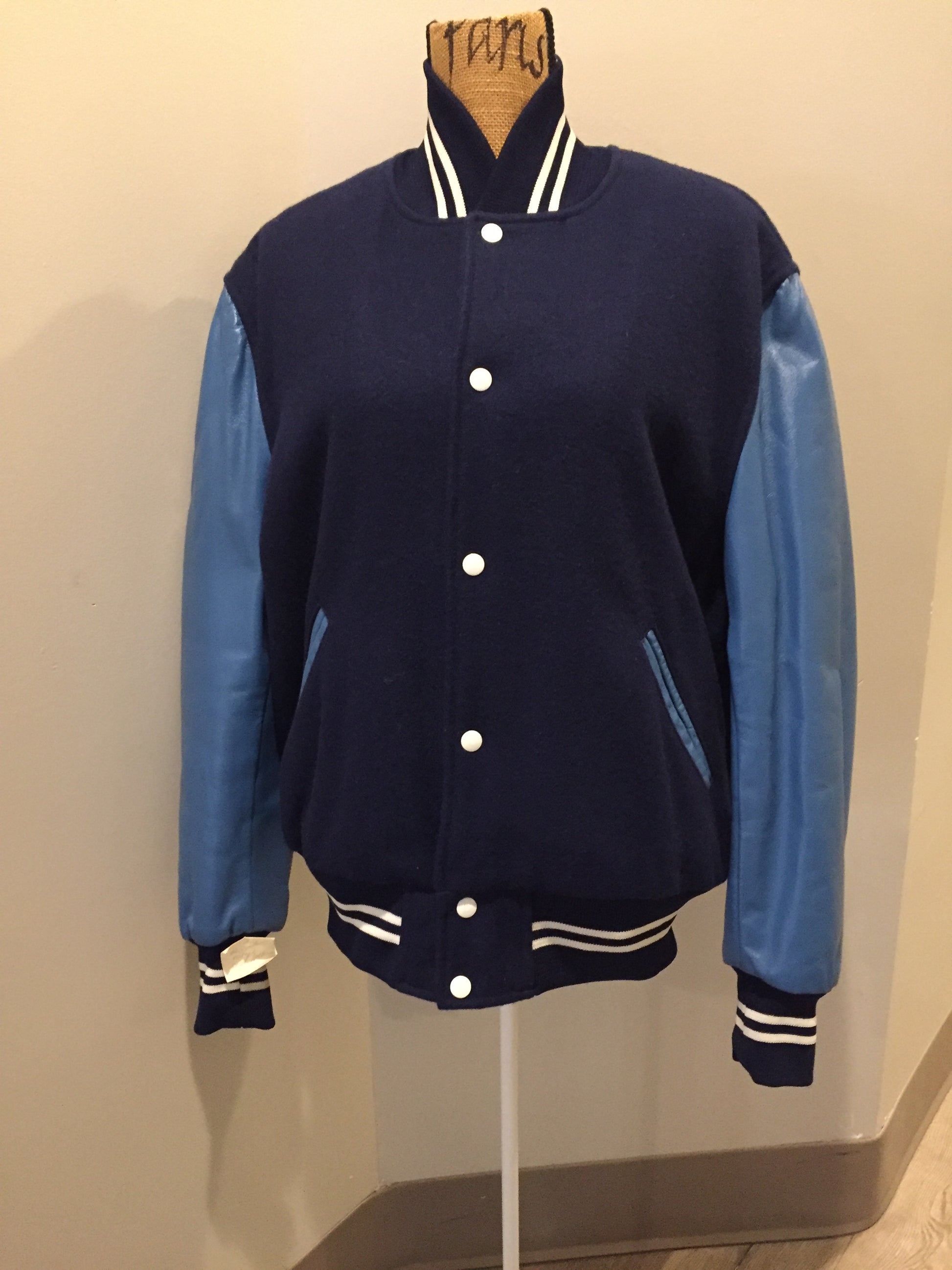 Kingspier Vintage - Blue wool varsity jacket with blue leather arms, snap closures, slash pockets and red quilted lining. Size 44.