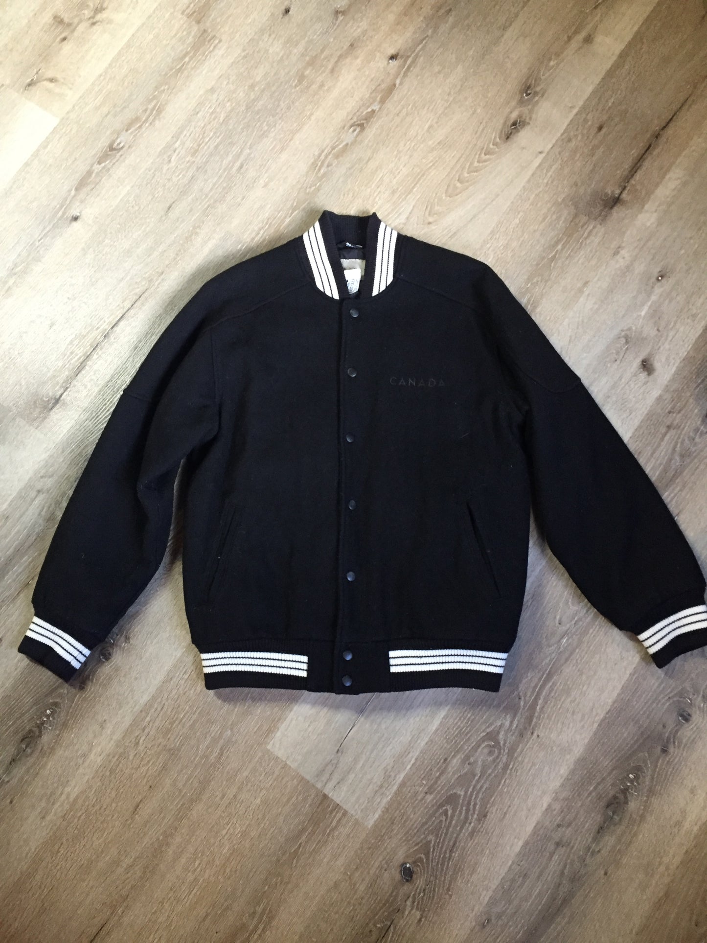 Kingspier Vintage - Retreat wool varsity jacket in black with ”Canada” printed on the chest,