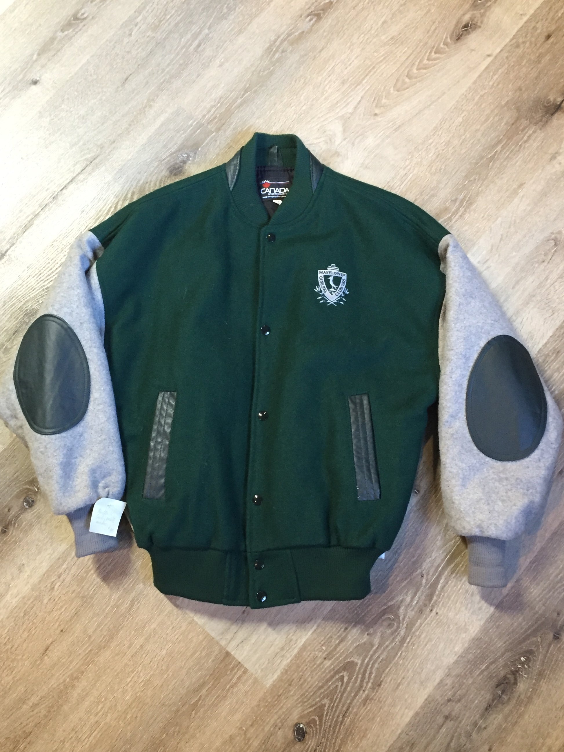 Kingspier Vintage - Mayflower Curling wool varsity jacket in green and grey with black leather accents, snap closures, slash pockets and emblem on chest. Made in Canada.