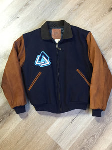 Kingspier Vintage - AES 1997 brown and blue leather and wool varsity jacket with zipper, slash pockets , quilted lining, inside pocket, embroidered emblem on the chest and “AES” printed across the back.