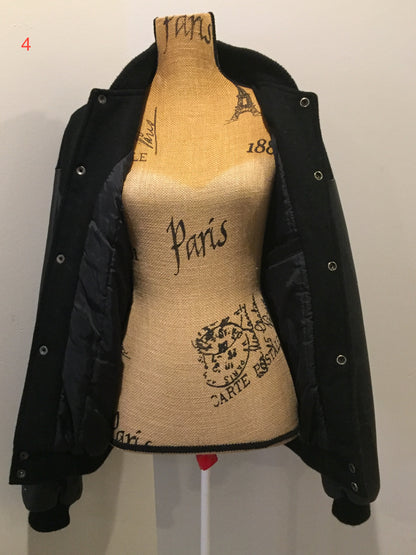 Kingspier Vintage - Konica “film and Cameras” wool and leather varsity jacket in black with snap closures, slash pockets, inside pocket and “get ready” written across the back with a race car illustration. Size large.