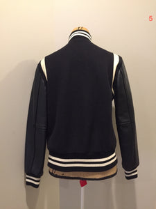Kingspier Vintage - Roots wool and leather black varsity jacket with white stripe details, knit trim, snap closures, slash pockets and inside pocket. Made in Canada. Ladies size S.