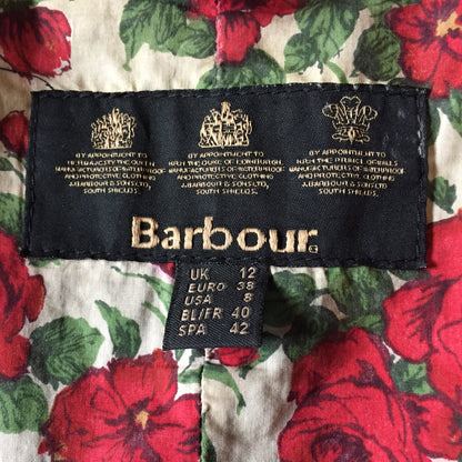 Kingspier Vintage - Barbour limited edition Rose Utility waxed cotton waterproof jacket in olive green with Liberty London print lining, snap and zip closure, four snap pockets on the front one inside zip pocket, zipper on the cuffs. moleskin inner collar & cuffs. MAde in the UK. Size US 8 US/ UK 12 women’s.