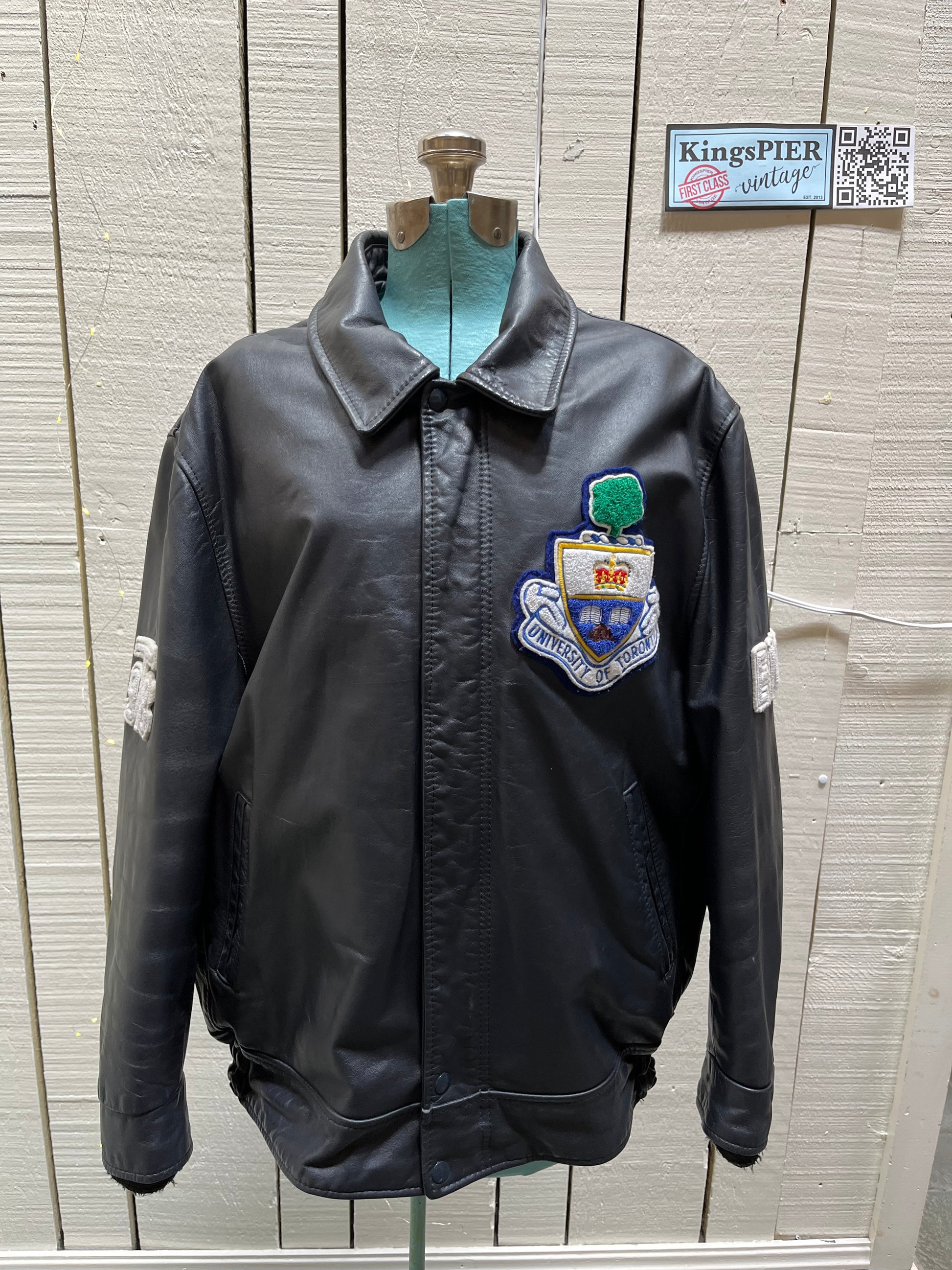 Vintage University of Toronto 1998 English Department Leather Varsity Jacket.

Jacket features embroidered details on the chest, arms and back, two front pockets, zipper and snap closures and a zip out quilted lining.

Size 46.