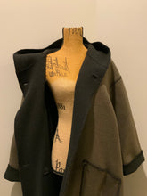 Load image into Gallery viewer, Kingspier Vintage - Linda Lundstrom full length black and brown reversible wool coat, double breasted with a hood and pockets on both sides. Made in New Glasgow, Nova Scotia. Size 16.
