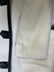 Kingspier Vintage - Genuine Hudson Bay Company 100% virgin wool coat in white with black leather trim, front pockets, flat black buttons and a unique mandarin collar with cape style detail around shoulders. Contains a Hudson’s Bay seal of quality tag. Made in Canada.