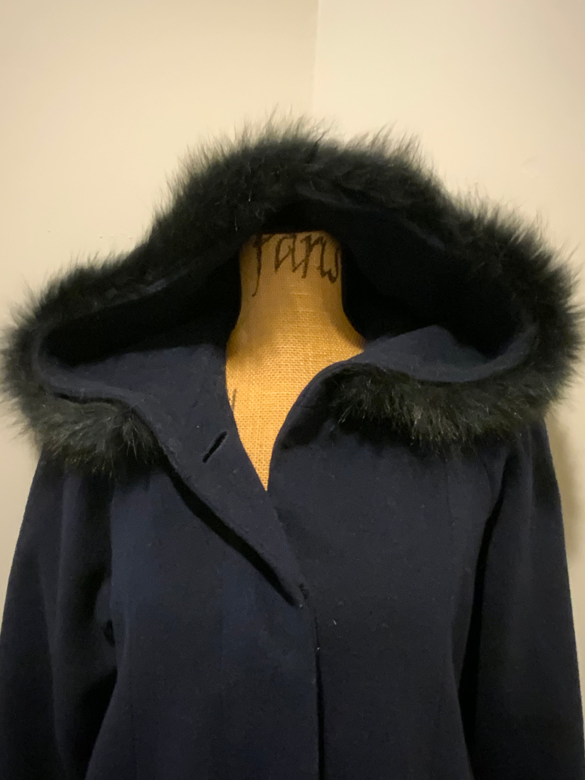 Kingspier Vintage - Braemar Petites by Jeremy Scott 1980’s/ 1990’s wool blend coat in navy blue with synthetic fur trim around the hood. Features hidden button closures down the front and slash pockets. Made in Romania