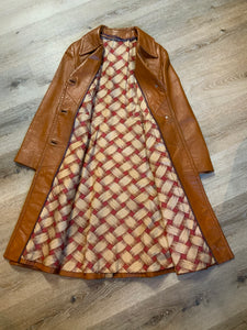 Kingspier Vintage - Form fitting 1970’s full length caramel brown leather coat with buttons down the front and a fun woven motif lining.