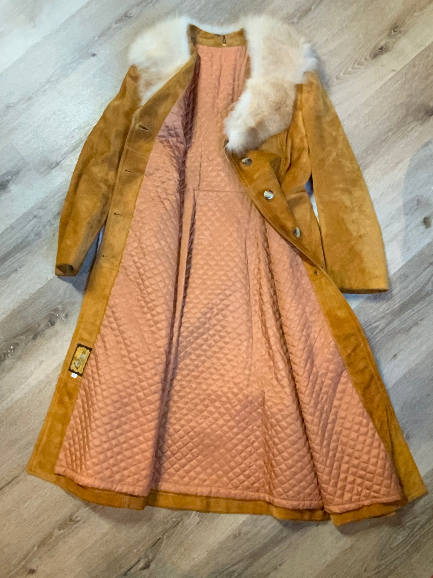 Kingspier Vintage - Embassy 1970’s full length tan suede coat with fur collar, button closures, pockets and a salmon coloured quilted lining. Made in Montreal, Canada. Fits Small.