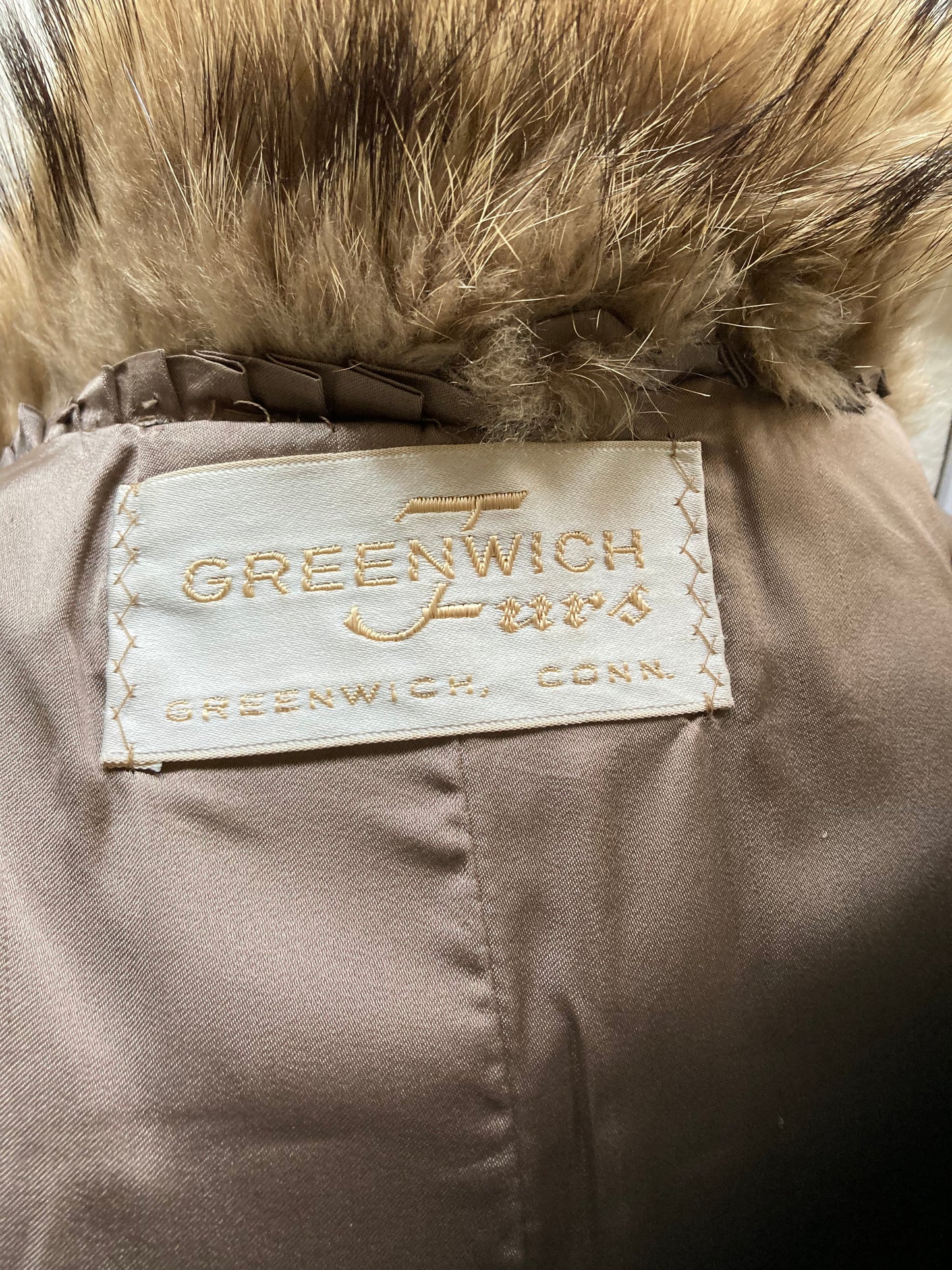 Kingspier Vintage - Vintage Greenwich Furs light brown fur coat with hook and eye closures and two front pockets.

Made in USA