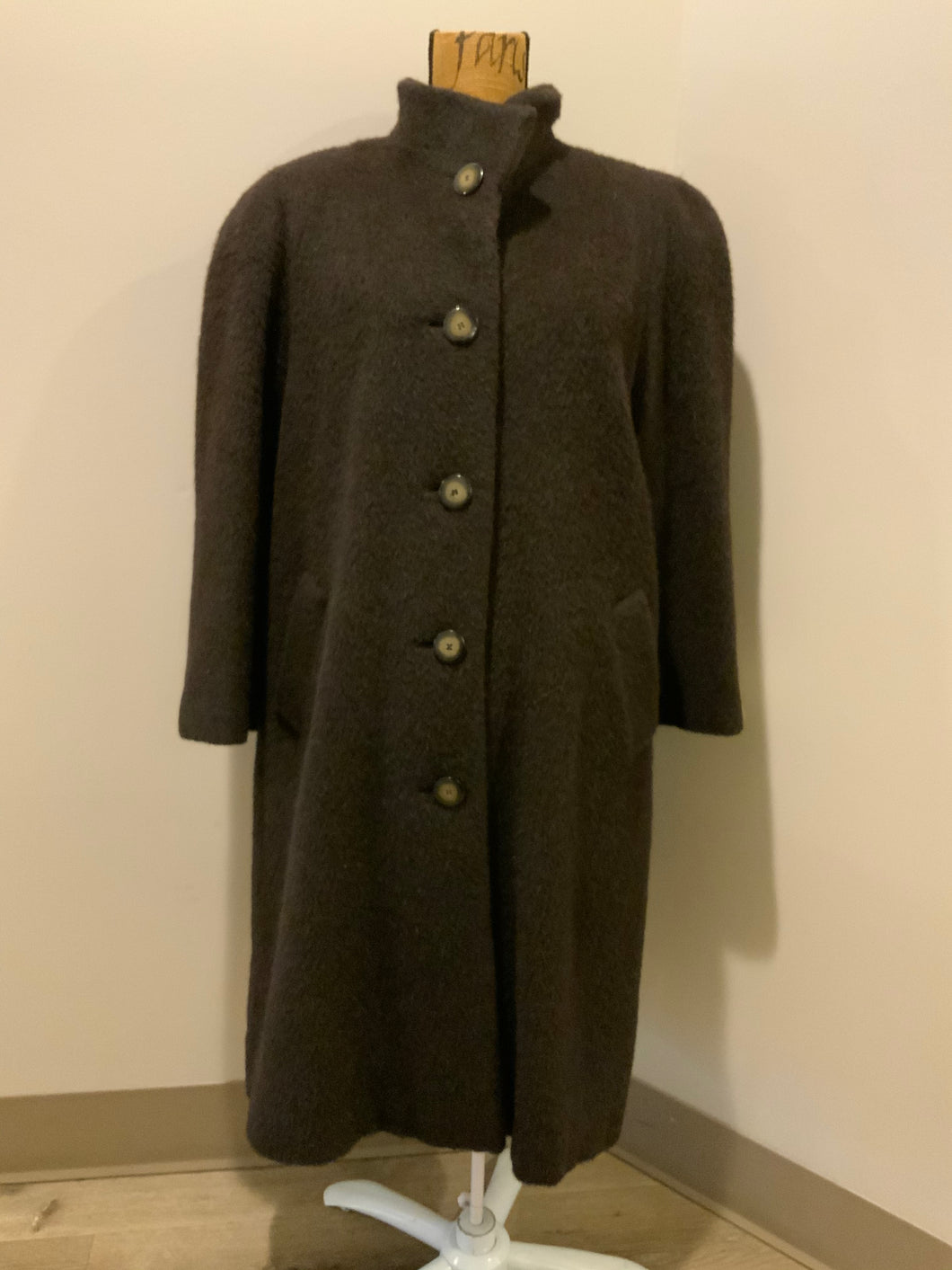 Kingspier Vintage - Regency 1970’s dark brown alpaca wool full length coat with front pockets and buttons, shoulder pads and pleating detail in the back. Features an ILGWU, Made in the USA label on inner lining. Fits a Size 8.
