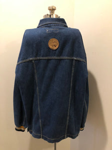 Kingspier Vintage - Vintage Knockout Jeans pullover denim jacket in a medium wash with quarter zip closure, embroidered logo on the front, knit cuffs, slash pockets, one patch pocket on the chest and a leather patch on the back. Size Xl. Made in USA