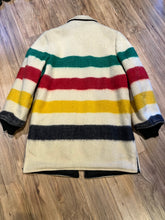 Load image into Gallery viewer, Genuine Hudson’s Bay Company 100% wool point blanket coat in the iconic multi-stripe colours. The coat features a reversible black nylon side with a hood zipped into the collar, zip pockets on both sides and knit cuffs.

Made in Canada. 
Chest measures 42”.
