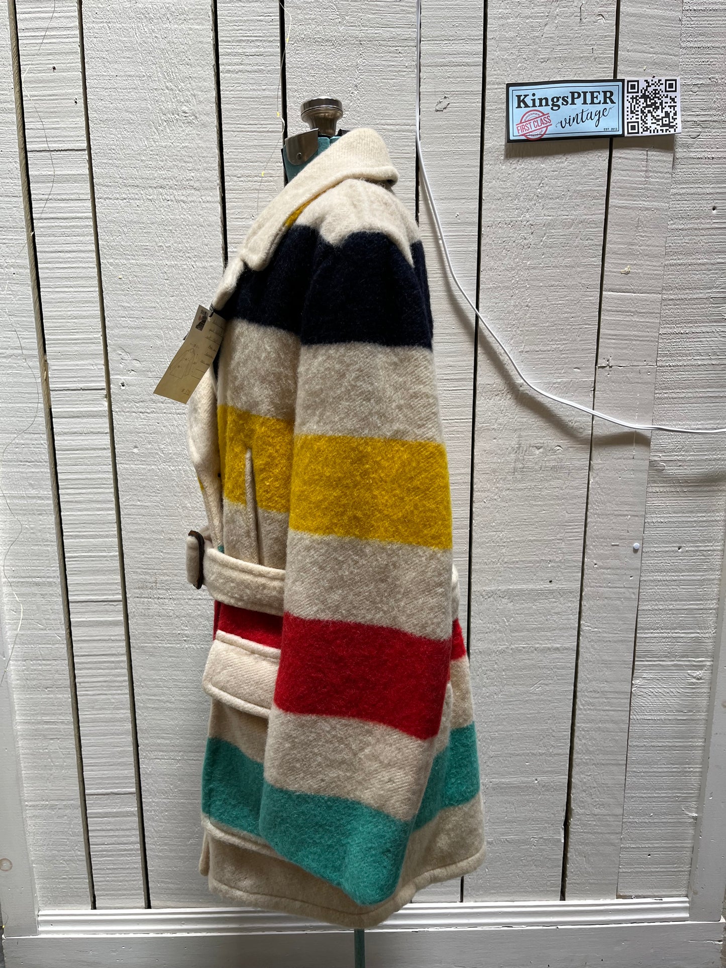 Genuine 1960’s Hudson’s Bay Company 100% wool point blanket coat in the iconic multi-stripe colours. The coat features flap pockets and hand warmer pockets, double breasted button closures and belt. 

Made in Canada. 
Chest 40”