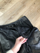 Load image into Gallery viewer, Danier black leather tapered leg pants with size zip closure, partially lined. Made in Canada. Size 2 (24x28).

