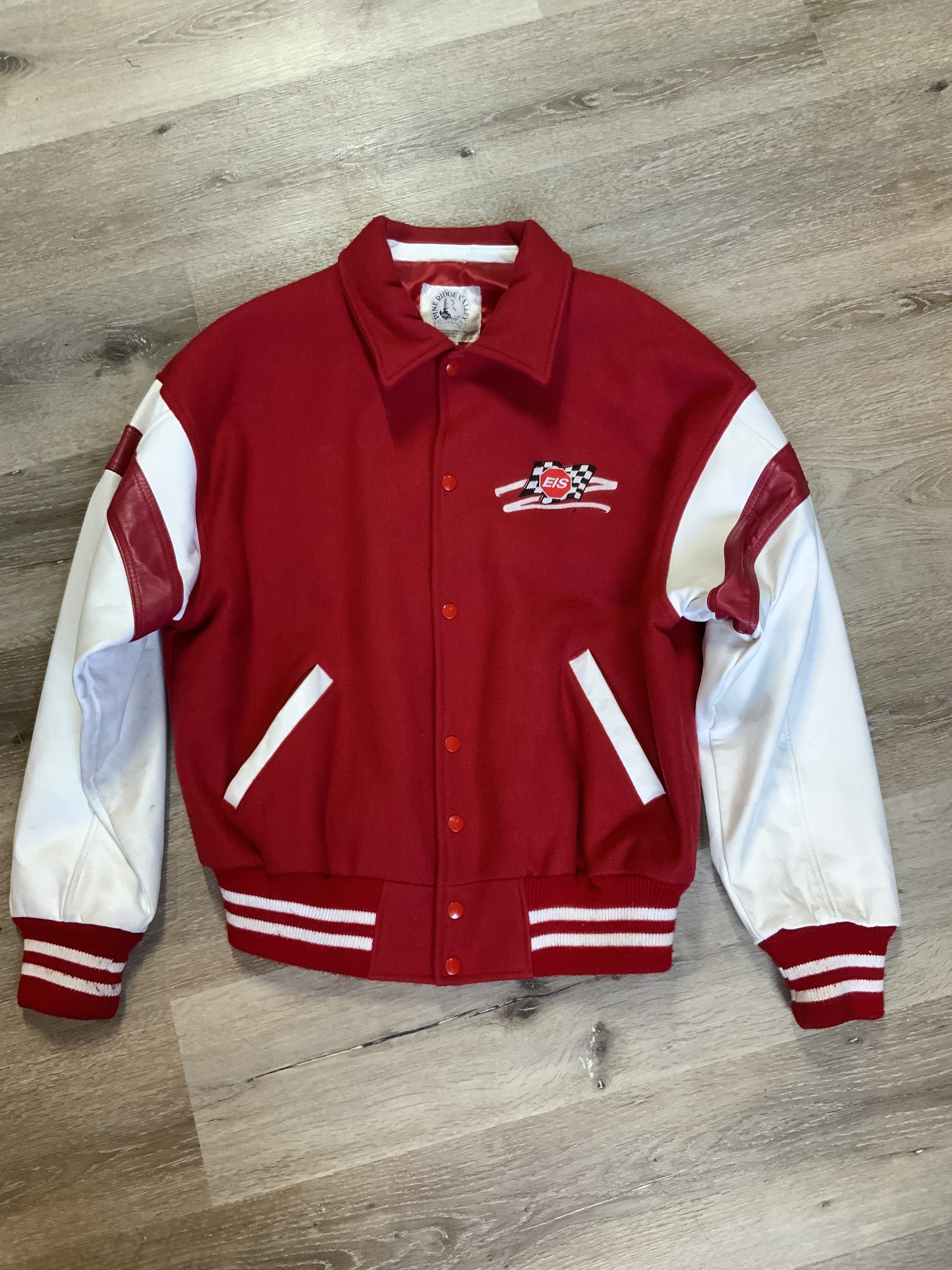 Kingspier Vintage - EIS red letterman’s jacket with white leather arms, race flag embroidered emblem, snap closures and slash pockets. Size large.