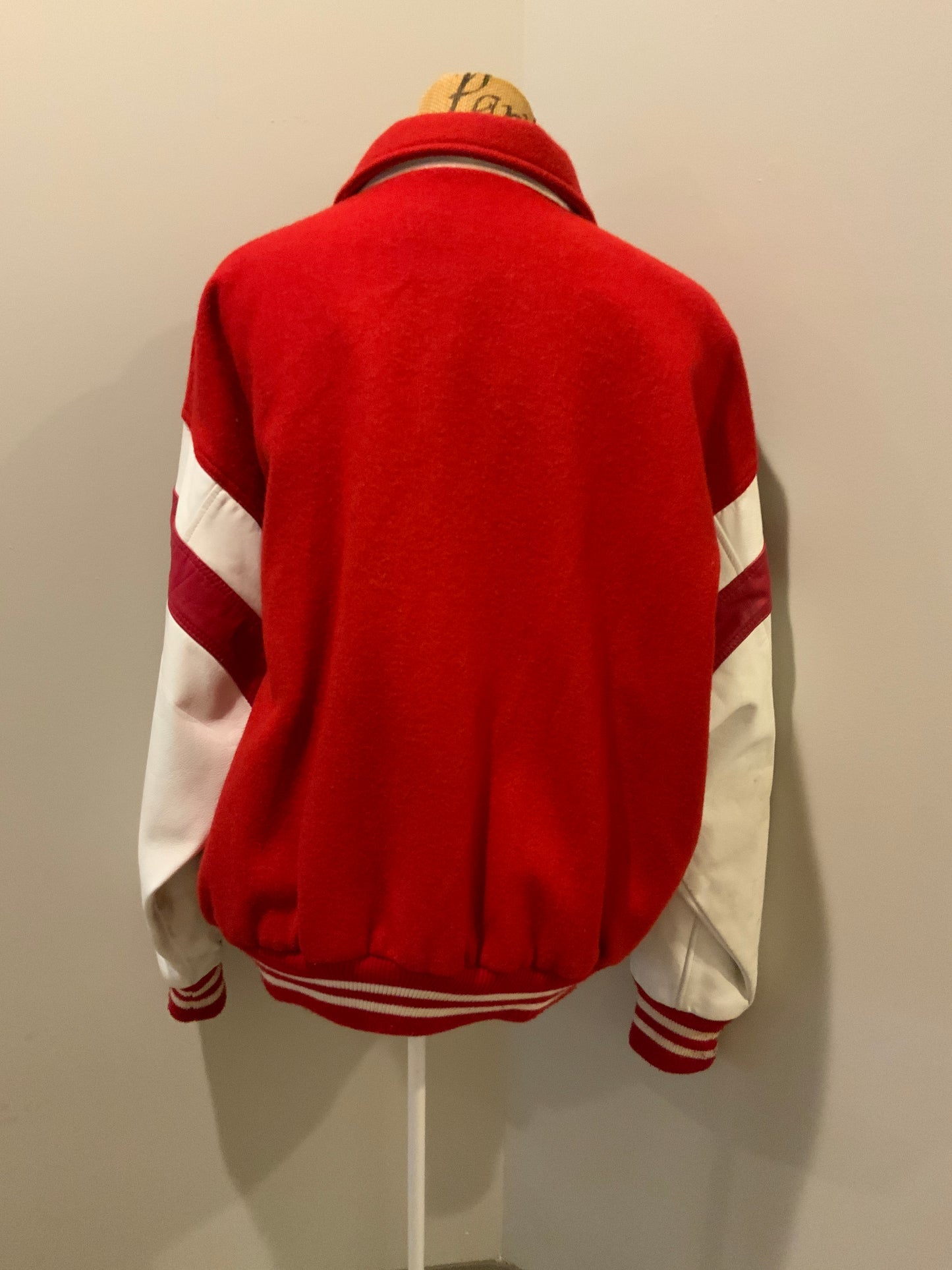 Kingspier Vintage - EIS red letterman’s jacket with white leather arms, race flag embroidered emblem, snap closures and slash pockets. Size large.