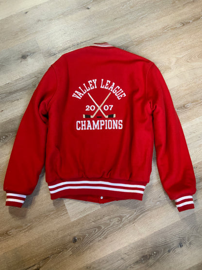 Kingspier Vintage - Melrose Youth Hockey letterman’s jacket in red with white accents, embroidered emblem on the front and lettering on the back with monogram on shoulder “Kevin”. Snap closures, slash pockets. Made in the USA. Size M.