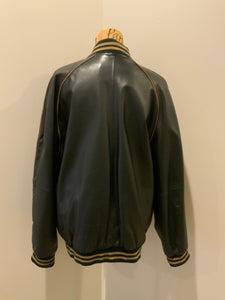 Kingspier Vintage - Retreat circa early 2000’s black leather bomber jacket with light brown stripe detailing, front zipper, slash front pockets and two inside pockets. Size 44.