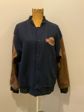 Load image into Gallery viewer, Kingspier Vintage - Ford F-Series 50 year anniversary letterman’s jacket in navy with brown leather sleeves, snap closures, slash pockets and an inside pocket.
