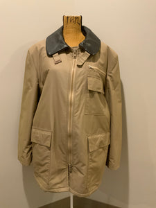 Kingspier Vintage - Special Reserve hunting jacket in beige with brown leather collar featuring a strap to keep your collar in place, zipper, three flap pockets and one zip pocket. Knit inside cuffs. lined for cooler weather with drawstring at waist. Made in Canada. Size 44. 