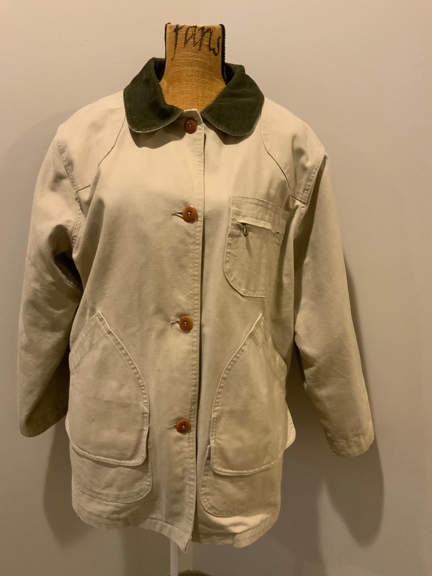 Kingspier Vintage - L.L.Bean beige field jacket with green corduroy collar and cuff, four front patch pockets and one zip pocket, button closures, removable plaid "Prima Loft" synthetic down lining. Size large petite women’s. 