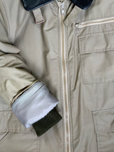 Load image into Gallery viewer, Kingspier Vintage - Special Reserve hunting jacket in beige with brown leather collar featuring a strap to keep your collar in place, zipper, three flap pockets and one zip pocket. Knit inside cuffs. lined for cooler weather with drawstring at waist. Made in Canada. Size 44. 
