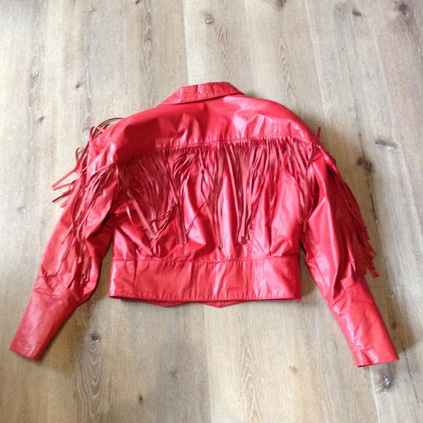 Kingspier Vintage - The Leather Ranch red fringe leather jacket with snap closures and red satin lining . Made in Canada, size XL.
