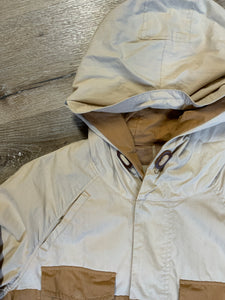 Kingspier Vintage - Tate beige and tan field jacket with hood, button closures, flap pockets, vent in the back, elbow patches and drawstring at the waist and the bottom hem. 