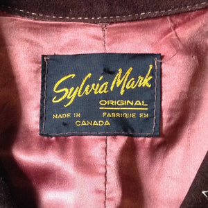 Kingspier Vintage - Vintage Sylvia Mark brown suede belted jacket with snap closures, decorative stitching, unique round pockets and pink satin lining. Made in Canada. Size Medium.
