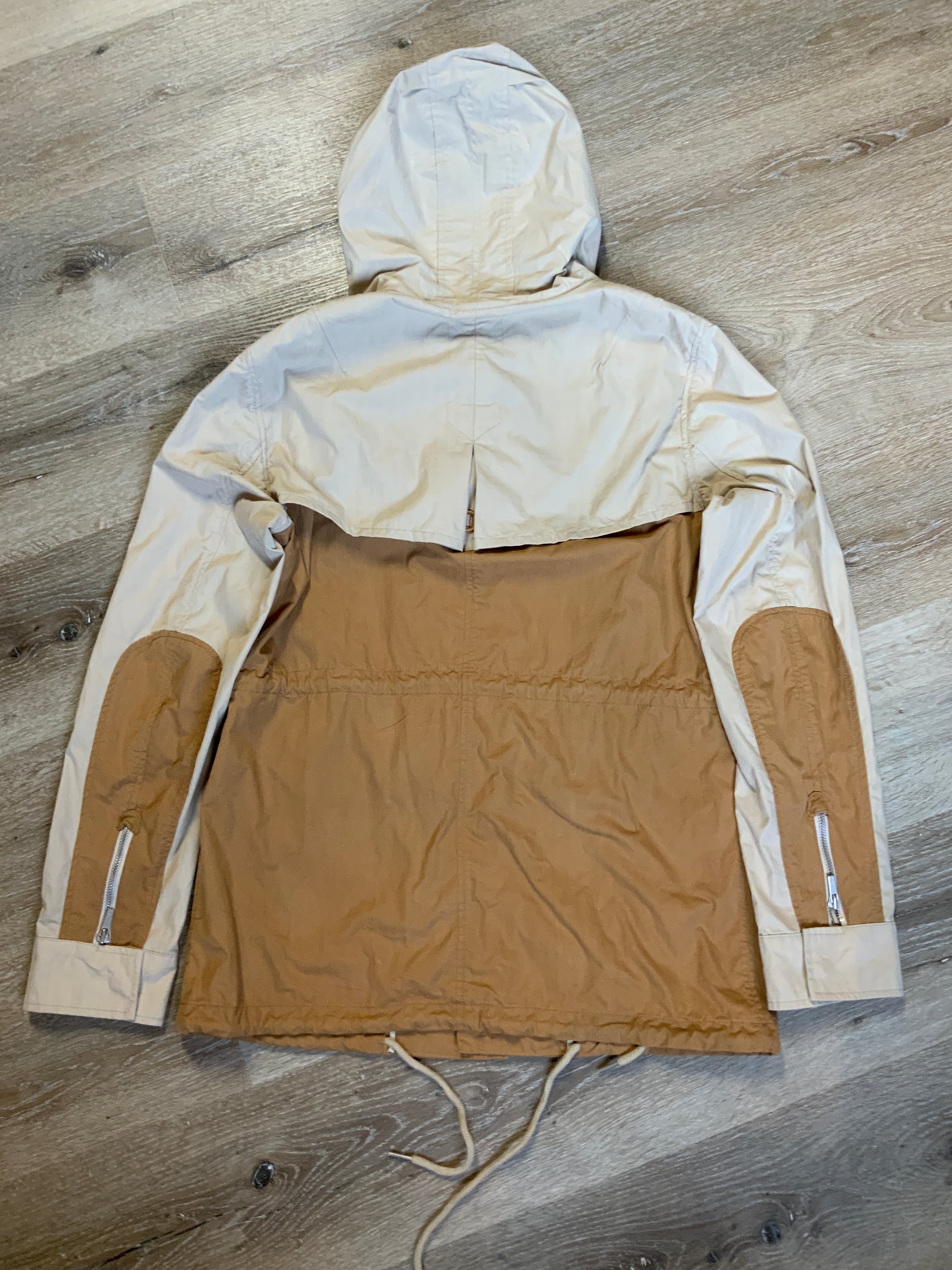 Kingspier Vintage - Tate beige and tan field jacket with hood, button closures, flap pockets, vent in the back, elbow patches and drawstring at the waist and the bottom hem. 