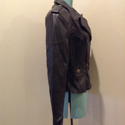 Kingspier Vintage -Vintage black leather moto jacket with brass hardware and zipper closure, belt details and a zipper reveals a vent in the back . Size large.
