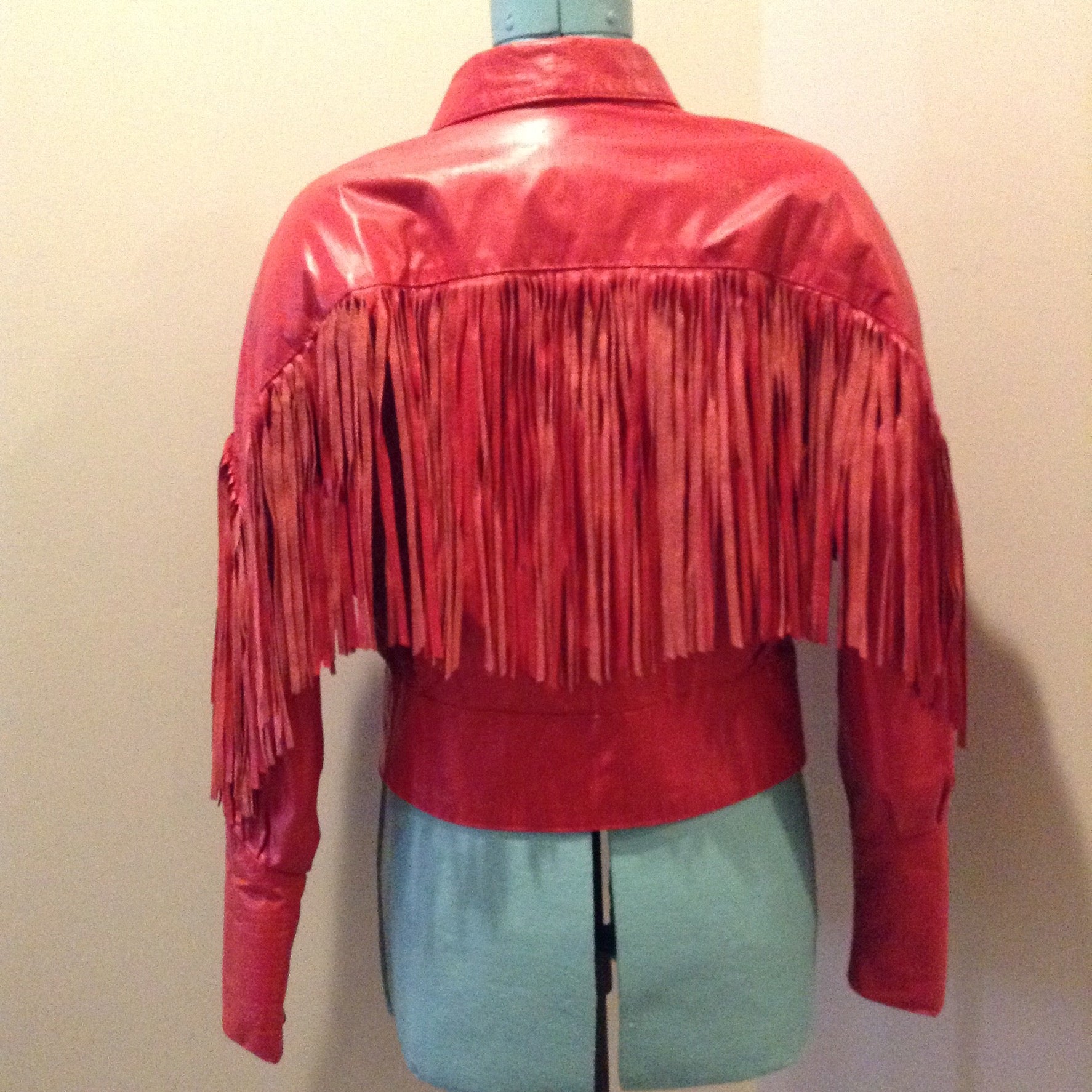 Kingspier Vintage - The Leather Ranch red fringe leather jacket with snap closures and red satin lining . Made in Canada, size XL.
