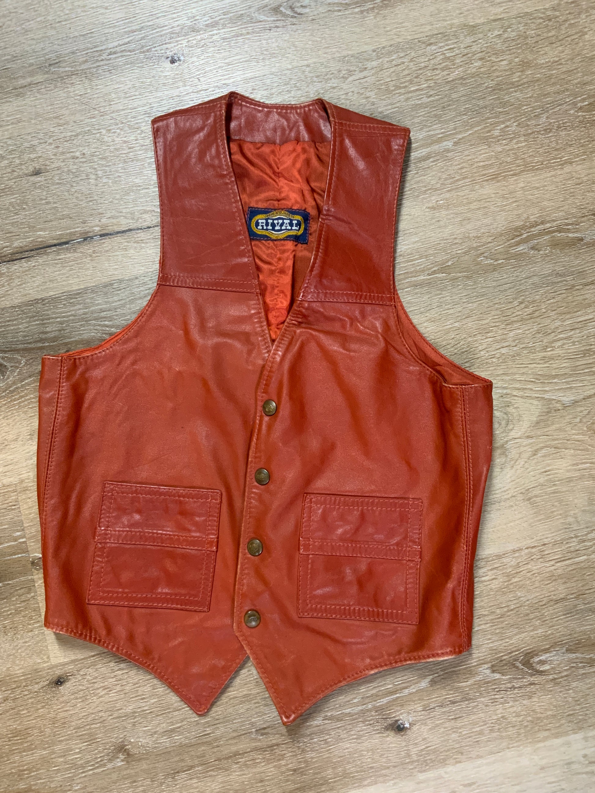 Kingspier Vintage - Rival rust leather vest with snap closures and patch pockets.