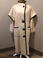 Load image into Gallery viewer, Kingspier Vintage - Genuine Hudson Bay Company 100% virgin wool coat in white with black leather trim, front pockets, flat black buttons and a unique mandarin collar with cape style detail around shoulders. Contains a Hudson’s Bay seal of quality tag. Made in Canada. 
