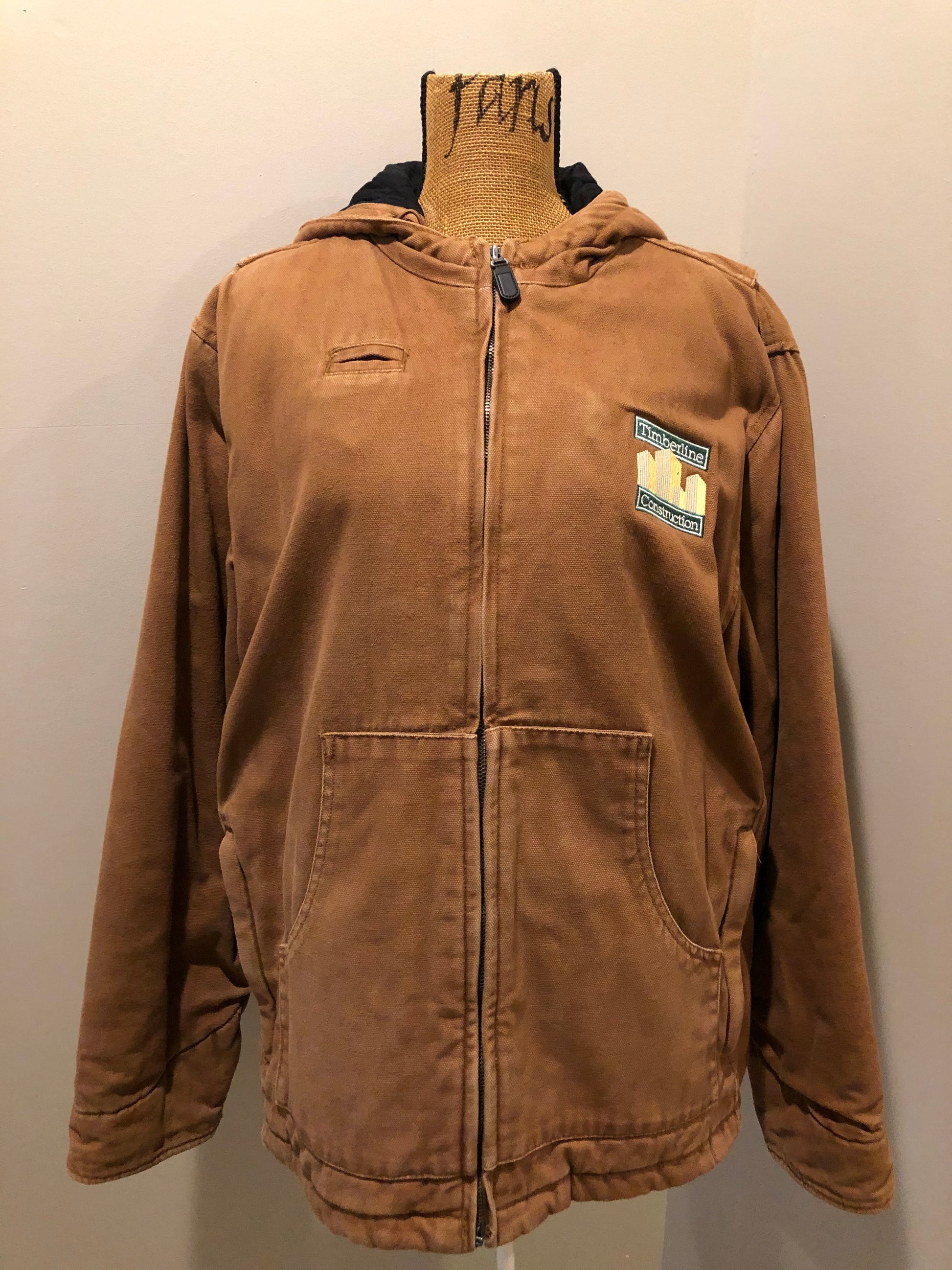 Kingspier Vintage - Charles River tan canvas work jacket with slash pockets, patch pockets, hood, “ timberline construction” embroidered emblem and quilted lining with inside pockets.