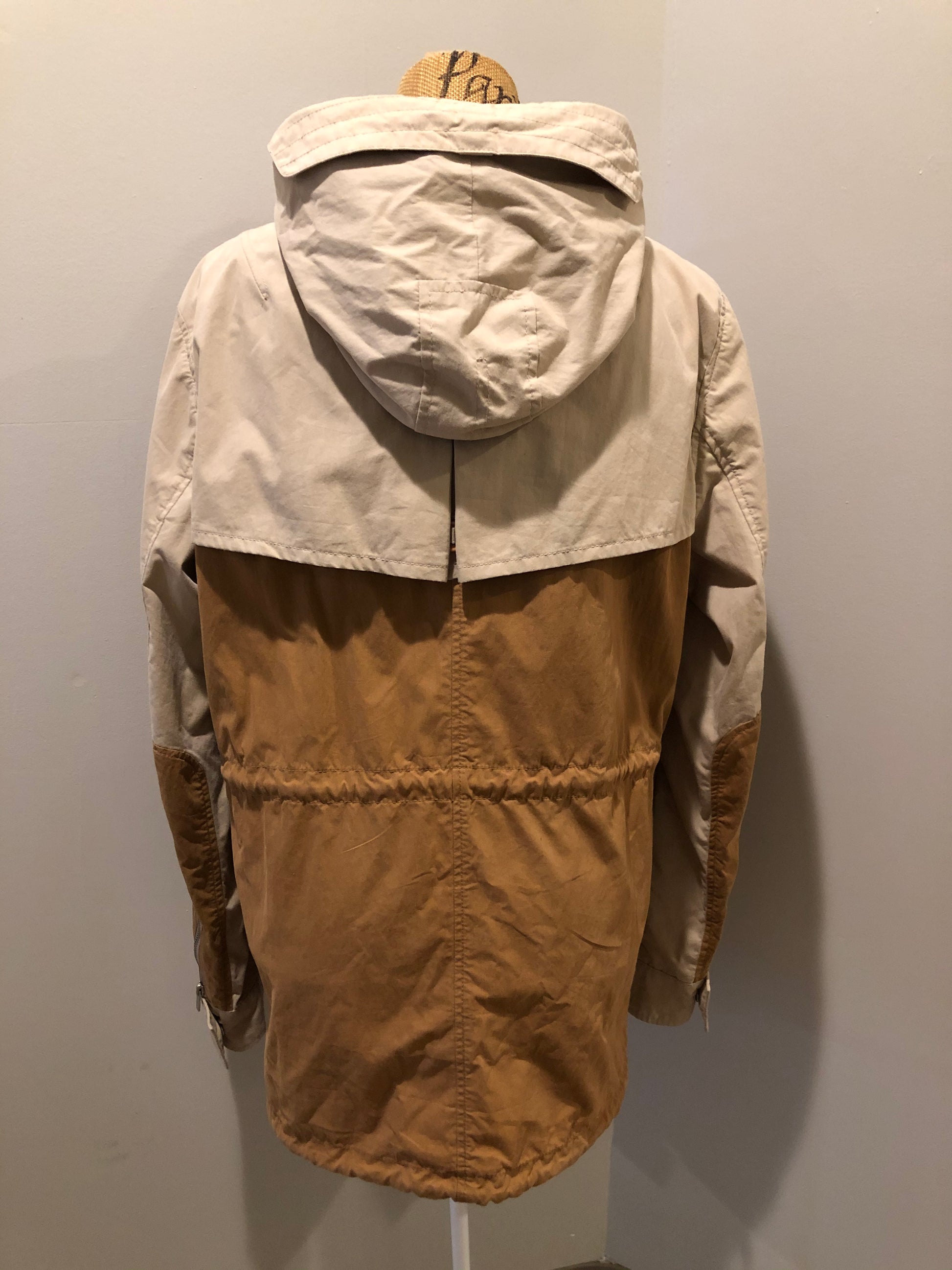 Kingspier Vintage - Tate beige and tan field jacket with hood, button closures, flap pockets, vent in the back, elbow patches and drawstring at the waist and the bottom hem. 