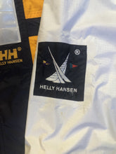 Load image into Gallery viewer, Kingspier Vintage - Heely Hansen ”Extreme” white,yellow and navy windbreaker with funnel neck and roll up hood, zipper and Velcro closures, reflective square on front and Helly Hansen patch on arm. Size XL.
