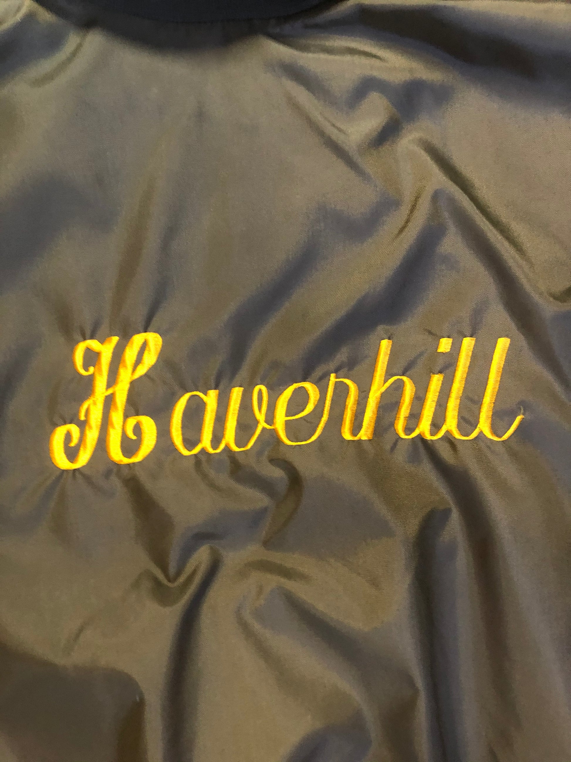 Kingspier Vintage - Havenhill High Soccer varsity jacket in brown with yellow stripe, zipper, front pouch pocket, “Havenhill High” written across the back and “Steph” monogram on the arm. Made in the USA. Size large. 