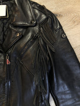 Load image into Gallery viewer, Kingspier Vintage - Hein Gericks black leather motorcycle jacket with fringe detail, zipper, vertical zip pockets lace-up shoulder detail, a quilted lining with inside pocket. Fits Small. 
