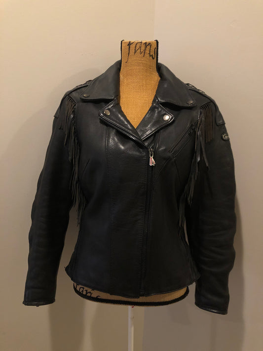 Kingspier Vintage - Hein Gericks black leather motorcycle jacket with fringe detail, zipper, vertical zip pockets lace-up shoulder detail, a quilted lining with inside pocket. Fits Small. 