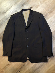 Kingspier Vintage - Bill Blass dark brown 100% pure wool two piece suit. The jacket is a single breasted three button notch lapel with two flap pockets and a beige lining with two inside pockets, Pants are pleated with welt pockets. 