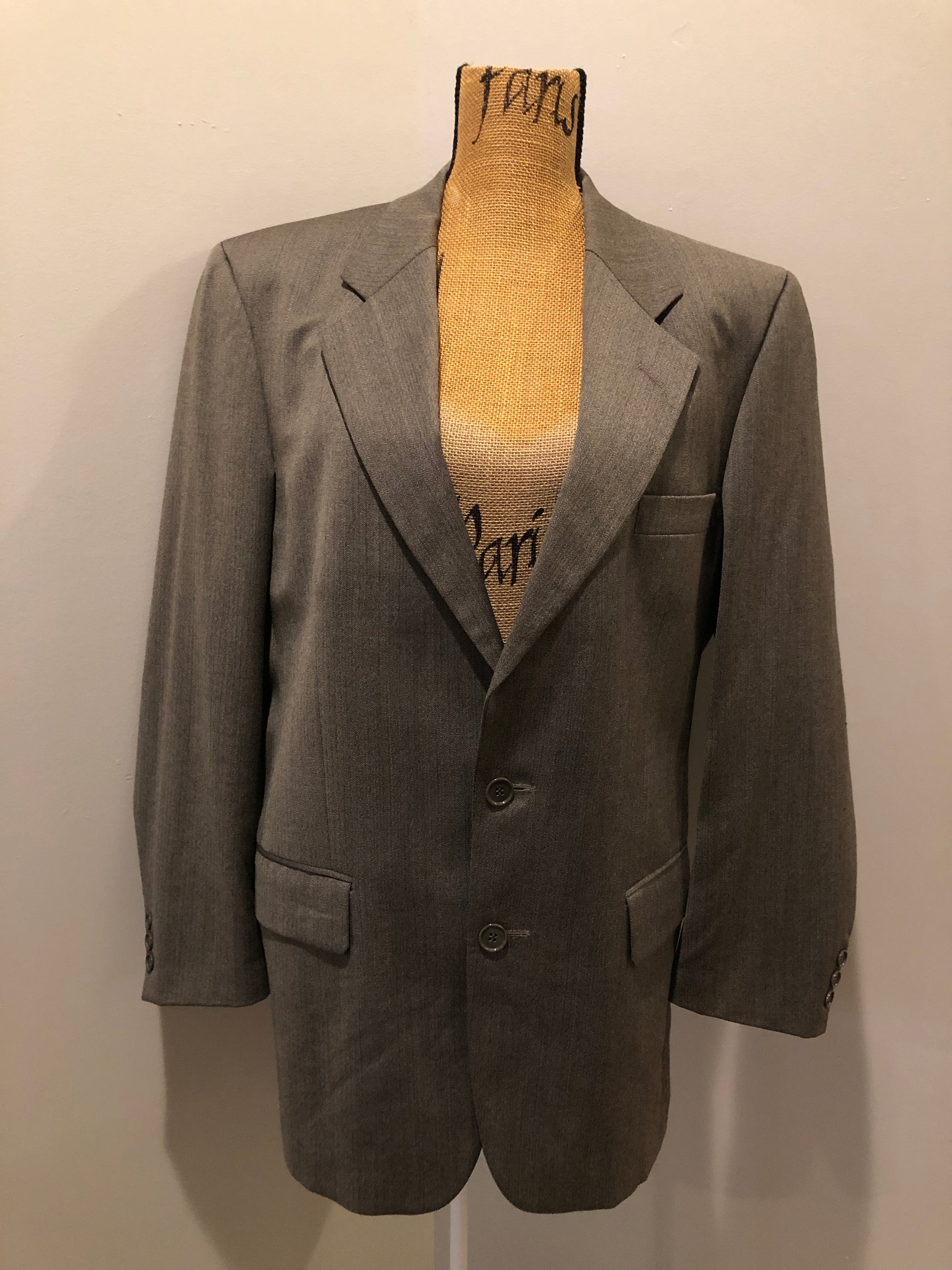 Kingspier Vintage - WM.H. Leishman ( at Tip Top Tailors) two piece medium grey 100% pure virgin wool suit.The jacket is a single breasted, two button notch lapel with two flap pockets and two inside pockets. Pants are pleated with welt pockets. Made in Canada. 