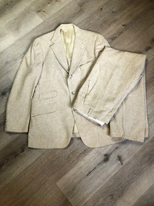 Kingspier Vintage - Chaps by Ralph Lauren light beige two piece suit  at Martini Carl Boston. Jacket is a three button notch lapel with three flap pockets and a breast pocket. The pants are flat front with two slash pockets, a tiny flap pocket in the front and two back pockets.